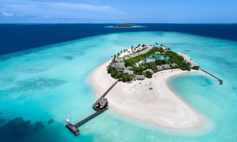 Couple walking on a beach in Maldives