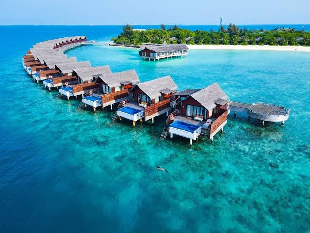 Couple walking on a beach in Maldives